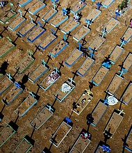 Since this year began, one third of all people who've died in Brazil were victims of Covid-19. Pictured is an aerial view of graves of COVID-19 victims at the Nossa Senhora Aparecida cemetery in Manaus, Amazon state, Brazil, on April 15, 2021.
Mandatory Credit:	Michael Dantas/AFP/Getty Images