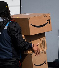 Amazon reported a whopping $8.1 billion in quarterly net income, up 224% from the same period in the prior year, crushing Wall Street analysts' prediction of $4.98 billion. An Amazon.com Inc. delivery driver carries boxes into a van outside of a distribution facility on February 2, 2021 in Hawthorne, California.
Mandatory Credit:	Patrick T. Fallon/AFP/Getty Images