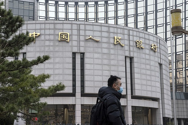 A pedestrian walks past the People's Bank of China (PBOC) building in Beijing, China, on Thursday, March 4.
Mandatory Credit:	Qilai Shen/Bloomberg/Getty Images