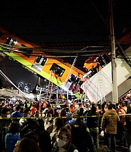 Rescuers work at a site where an overpass for a metro partially collapsed with train cars on it at Olivos station in Mexico City, Mexico May 3.
Mandatory Credit:	Luis Cortes/Reuters