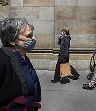 People walk along 42nd Street in New York City on April 27, 2021.
Mandatory Credit:	Anthony Behar/Sipa USA/AP
