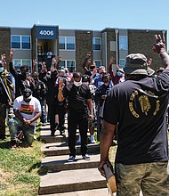 Cruz Sherman, founder of Men in Action, leads a prayer during a rally Saturday of community members and public officials seeking solutions to stop the city’s gun violence. Group members hold up three fingers in tribute to 3-month-old Neziah Hill, who was shot and killed with her 30-year-old mother, Sharnez Hill, on April 27 in the courtyard of the Belt Atlantic Apartments on Midlothian Turnpike. Three others were wounded. The rally was held in view of the apartment complex. Among the officials attending the rally were U.S. Sen. Tim Kaine, state Sen. Joseph D. “Joe” Morrissey, Richmond Police Chief Gerald M. Smith, Henrico Police Chief Eric D. English, Richmond Sheriff Antionette V. Irving, Richmond Commonwealth’s Attorney Colette W. McEachin, Richmond Public Schools Superintendent Jason Kamras and Henrico County Sheriff Alisa Gregory.