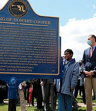 Maryland Gov. Larry Hogan, far right, Baltimore County Executive John Olszewski and Maryland House Speaker Adrienne Jones stand next to a new historic marker on Saturday in Towson, Maryland, that memorializes Howard Cooper, a 15-year-old who was dragged from a jailhouse and hanged from a tree by a mob of white men in 1885.
Mandatory Credit:	Brian Witte/AP