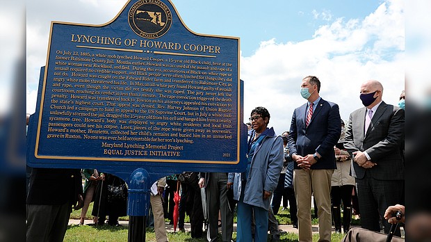 Maryland Gov. Larry Hogan, far right, Baltimore County Executive John Olszewski and Maryland House Speaker Adrienne Jones stand next to a new historic marker on Saturday in Towson, Maryland, that memorializes Howard Cooper, a 15-year-old who was dragged from a jailhouse and hanged from a tree by a mob of white men in 1885.
Mandatory Credit: Brian Witte/AP
