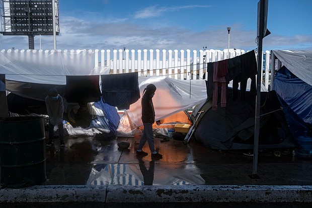 A migrant girl walks at an improvised camp outside El Chaparral crossing port as she and another wait for US authorities to allow them to start their migration process in Tijuana, Baja California state, Mexico, on March 11.
Mandatory Credit: GUILLERMO ARIAS/AFP/AFP via Getty Images