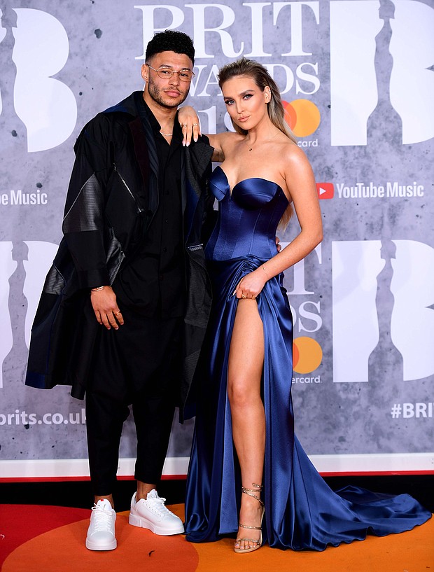 Little Mix star Perrie Edwards has announced that she is expecting her first child with England footballer Alex Oxlade-Chamberlain.
Mandatory Credit: Ian West/PA Images/Getty Images