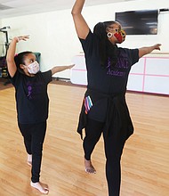 Me and my shadow-Daphne Lions, 6, mirrors dance techniques taught last Saturday by her instructor, Cynthia Thomas Rustin, owner and operator of World Fitness Dance Academy in Glen Allen. As part of COVID-19 safety protocol, dance students wear masks, have their temperatures taken, wash their hands and feet and stay socially distanced.