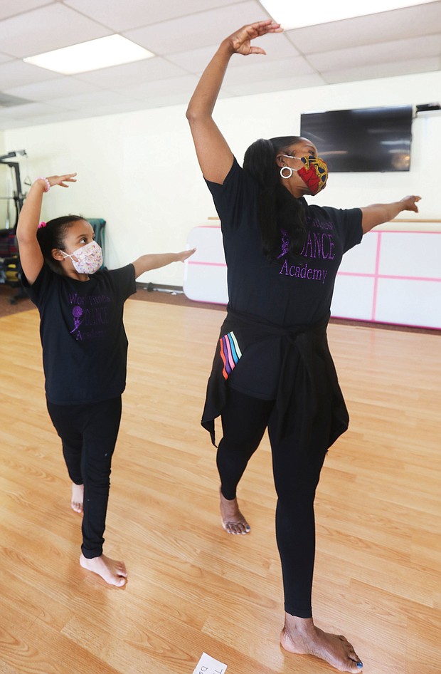 Me and my shadow-Daphne Lions, 6, mirrors dance techniques taught last Saturday by her instructor, Cynthia Thomas Rustin, owner and operator of World Fitness Dance Academy in Glen Allen. As part of COVID-19 safety protocol, dance students wear masks, have their temperatures taken, wash their hands and feet and stay socially distanced.