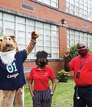 Ashley Bland pauses for a photo with John B. Cary’s Principal Michael Powell and the school mascot following the announcement.