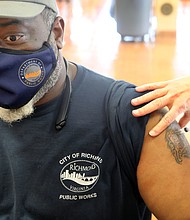 David Carter, 49, an employee of the Richmond Department of Public Works, receives the single-dose Johnson & Johnson COVID-19 vaccine May 5 during a walk-up vaccination clinic held at George Wythe High School by the Richmond and Henrico health districts. No appointments are needed for the health districts’ clinics. The school at 4314 Crutchfield St. in South Richmond will be among several sites offering inoculations during the coming days. The next vaccine clinics at George Wythe will be noon to 5 p.m. Tuesday, May 18, and 3 to 6 p.m. Wednesday, May 19. The Johnson & Johnson vaccine will be available, along with the two- dose Pfizer vaccine.