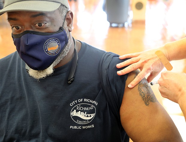 David Carter, 49, an employee of the Richmond Department of Public Works, receives the single-dose Johnson & Johnson COVID-19 vaccine May 5 during a walk-up vaccination clinic held at George Wythe High School by the Richmond and Henrico health districts. No appointments are needed for the health districts’ clinics. The school at 4314 Crutchfield St. in South Richmond will be among several sites offering inoculations during the coming days. The next vaccine clinics at George Wythe will be noon to 5 p.m. Tuesday, May 18, and 3 to 6 p.m. Wednesday, May 19. The Johnson & Johnson vaccine will be available, along with the two- dose Pfizer vaccine.