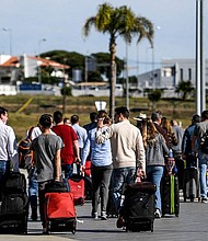 Travelers from the UK arrive in Portugal on the first day of post-restriction travel.
Mandatory Credit:	PATRICIA DE MELO MOREIRA/AFP via Getty Images