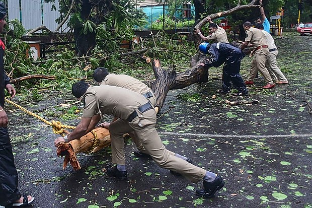 Police clear fallen trees from a road following heavy rains and strong winds brought by Cyclone Tauktae, at Panjim, Goa on May 16.
Mandatory Credit: Umesh Zarmekar/AFP/Getty Images