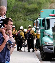 Pacific Palisades resident Mike Sutton, 31, and his son, Tommy, 2, watch the deployment of firefighters on May 16.
Mandatory Credit:	Ringo H.W. Chiu/AP
