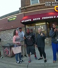 This May 25, 2020, file image from a police body camera shows bystanders including Darnella Frazier, third from right, recording Floyd's final minutes.
Mandatory Credit:	Minneapolis Police Department/AP/File