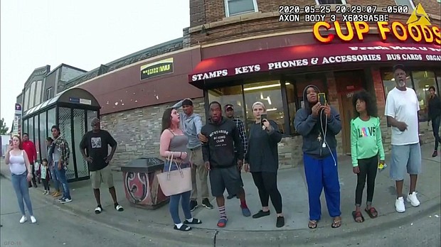 This May 25, 2020, file image from a police body camera shows bystanders including Darnella Frazier, third from right, recording Floyd's final minutes.
Mandatory Credit:	Minneapolis Police Department/AP/File