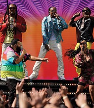 DJ Khaled, front left, and H.E.R., front right, perform with Takeoff, from background left, Quavo and Offset, of Migos, at the Billboard Music Awards on Sunday at the Microsoft Theater in Los Angeles.