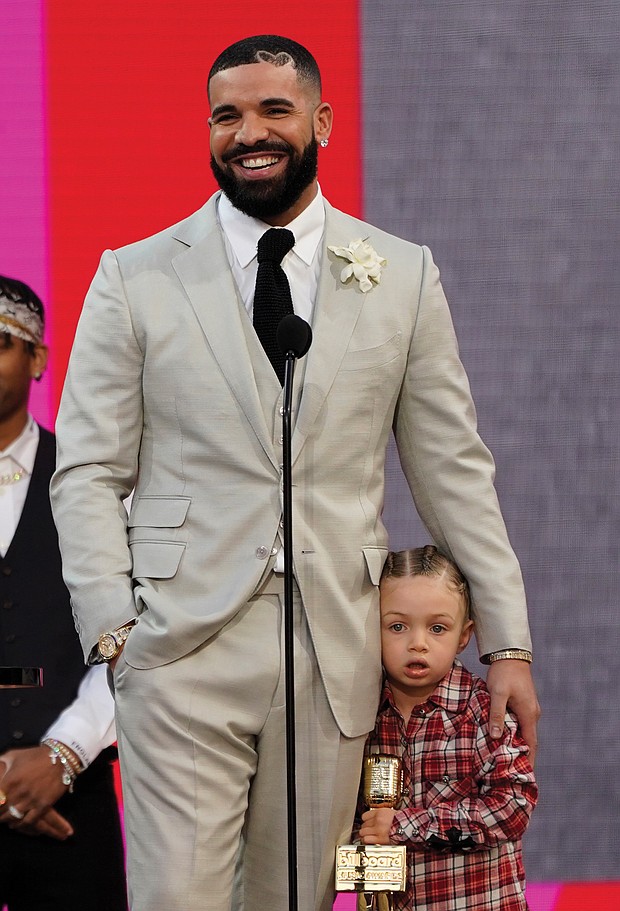 Drake accepts the artist of the decade award as he hugs his son Adonis Graham.