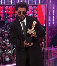 The Weeknd accepts the top artist award.