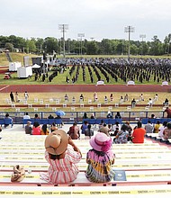 Graduates’ families and friends are seated socially distanced in the stadium during Virginia State University’s commencement.