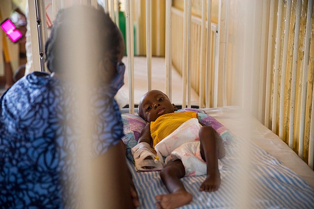 Marie Rose Emile watches over her 6-month-old grandson Jonise as he is treated for malnutrition in Haiti on May 26.
Mandatory Credit: Joseph Odelyn/AP