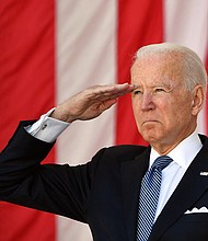President Joe Biden salutes before delivering an address at the 153rd National Memorial Day Observance at Arlington National Cemetery on May 31.
Mandatory Credit: Mandel Ngan/AFP/Getty Images