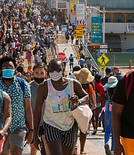 People crowd the Santa Monica Pier in Santa Monica, California, on May 29. Californians are celebrating the Memorial Day weekend, more upbeat than they have been for any other holiday.
Mandatory Credit: Damian Dovarganes/AP