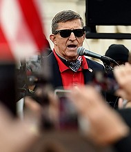 Former national security adviser Michael Flynn is seen as a hero in the QAnon movement.
Mandatory Credit: Olivier Douliery/AFP/Getty Images