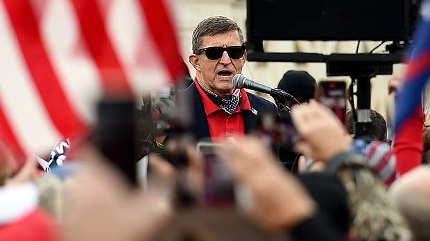 Former national security adviser Michael Flynn is seen as a hero in the QAnon movement.
Mandatory Credit:	Olivier Douliery/AFP/Getty Images