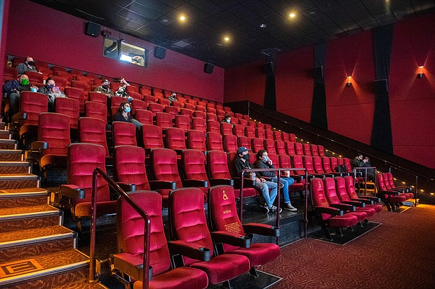 Moviegoers sit, waiting for their movie to start at the AMC Burbank theatre on reopening day in Burbank, California, March 15. Shares of AMC — the largest movie theater chain in the world — surged more than 90% early June 2 to a new peak above $60.
Mandatory Credit:	Valerie Macon/AFP/Getty Images