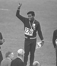 U.S. Olympic team sprinter Lee Evans, center, puts his fist up in a Black Power salute and protest against racism during the medal ceremony at the 1968 Summer Olympics in Mexico City. He and teammates Larry James, left, and Ron Freeman also wore black berets in protest while receiving their medals in the 400-meter race. Evans’ gold medal win in running 400 meters in 43.86 seconds set a record that stood until 1988.