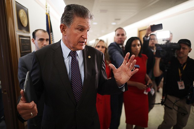 Sen Joe Manchin talks to reporters about his support for a January 6 commission while walking down the hall of the Dirksen Senate Office Building on May 27 in Washington, DC. Manchin would not commit to backing an infrastructure package along straight party lines on June 16.
Mandatory Credit:	Chip Somodevilla/Getty Images