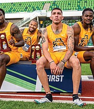 North Carolina A&T State University sprinters, from left, Akeem Sirleaf, Trevor Stewart, Daniel Stokes and Randolph Ross Jr. show off their trophies from winning the 4x400 meter relay last weekend at the NCAA Outdoor Track and Field Championships in Oregon.