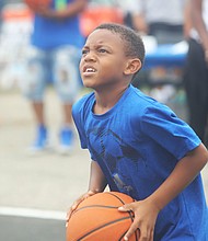 New court in Church Hill/Dallas Ashford, 8, who has his eye on the hoop as he focuses to take a shot.is on the newly unveiled basketball court behind Mt. Olivet Church at 1223 N. 25th St. in Church Hill. Team Loaded and FeedTheStreetsRVA partnered to bring “Operation Homebase” to the area last Saturday, which included unveiling the court and giving new shoes and T-shirts to youths and providing activities and food at the free community gathering.