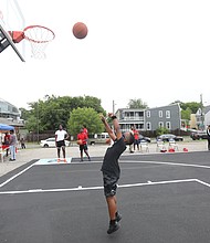 New court in Church Hill/ Christian Ballard, 9, shows off his skills on the newly unveiled basketball court behind Mt. Olivet Church at 1223 N. 25th St. in Church Hill. Team Loaded and FeedTheStreetsRVA partnered to bring “Operation Homebase” to the area last Saturday, which included unveiling the court and giving new shoes and T-shirts to youths and providing activities and food at the free community gathering.