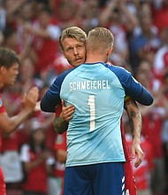 Simon Kjaer and Kasper Schmeichel of Denmark interact as the ball is kicked out of play in the tenth minute followed by a minute of applause in support of Denmark International Christian Eriksen.
Mandatory Credit: Jonathan Nackstrand/Pool/Getty Images