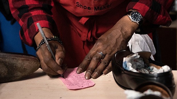 A shoe cobbler working in a black-owned business in Washington, DC.
Mandatory Credit:	Brendan Smialowski/AFP/Getty Images