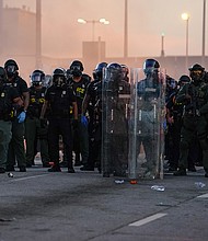 A police line is seen in Atlanta during a protest last summer in response to the murder of George Floyd.
Mandatory Credit:	Elijah Nouvelage/Getty Images