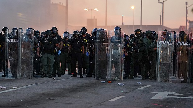 A police line is seen in Atlanta during a protest last summer in response to the murder of George Floyd.
Mandatory Credit:	Elijah Nouvelage/Getty Images