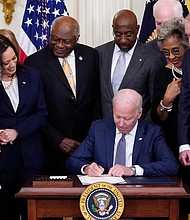 President Joe Biden signs the Juneteenth National Independence Day Act, in the East Room of the White House on June 17 in Washington.
Mandatory Credit:	Evan Vucci/AP