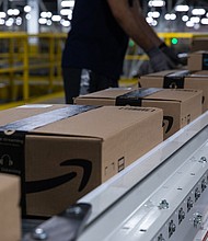 Boxes move along a conveyor belt at an Amazon fulfillment center on Prime Day in Raleigh, North Carolina on June 21. Amazon.com's annual Prime Day sale arrives as the world grapples with the lingering effects of the pandemic.
Mandatory Credit:	Rachel Jessen/Bloomberg/Getty Images