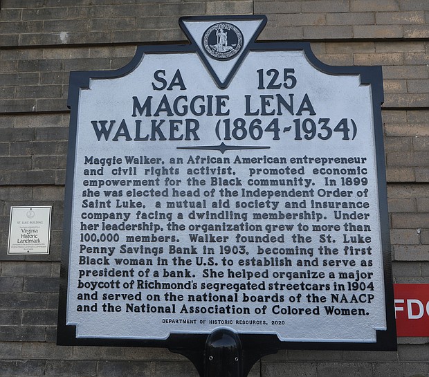 A new historic marker honoring Richmond business and civil rights leader Maggie L. Walker sits in front of the historic St. Luke Building that has stood in the 900 block of St. James Street in Gilpin Court since 1903. 
Now a 12-unit apartment building with first-floor commercial space, the building began life as the national headquarters of the United Order of St. Luke, a Black fraternal and insurance group led by Mrs. Walker from 1899 until her death in 1934. Making bold moves, she pushed the fraternal order into developing the headquarters and taking other entrepreneurial action, including opening a bank.