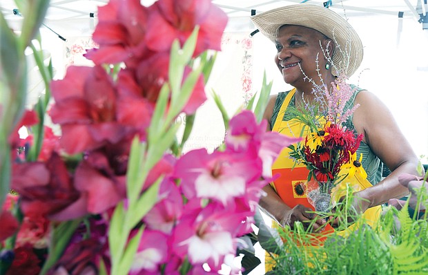 Barbara Payton of Barb’s Blooms stands among the festive flowers in her booth at the RVA Black Farmers Market on Saturday at 1700 Blair St. in the city’s West End.