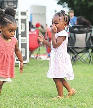 Juneteenth fun/Gabrielle Holmes, left, and Serenity Johnson dance to the sounds of gospel at “Juneteenth: Sounds of Freedom Celebration” held last Saturday evening on the lawn at Virginia Union University. The 2-year-olds were enjoying the event with family. It was one of several area commemorations of the new national holiday.