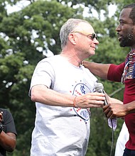 U.S. Sen. Tim Kaine, left, and Mayor Levar M. Stoney embrace in a show of unity after the senator’s remarks and introduction of the mayor during the “Love and Legacy Juneteenth Jubilee Celebration” at the Landing at Fountain Lake in Byrd Park. The event, organized by Sherri Robinson of ShowLove LLC, featured music, dance, entertainment, children’s activities and information about community resources.