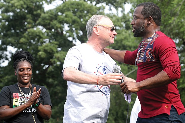 U.S. Sen. Tim Kaine, left, and Mayor Levar M. Stoney embrace in a show of unity after the senator’s remarks and introduction of the mayor during the “Love and Legacy Juneteenth Jubilee Celebration” at the Landing at Fountain Lake in Byrd Park. The event, organized by Sherri Robinson of ShowLove LLC, featured music, dance, entertainment, children’s activities and information about community resources.