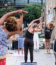 Kiran Bhagat leads a yoga class Saturday at the Juneteenth Freedom Day celebration at the 17th Street Market, featuring drumming, dancing and meditation.