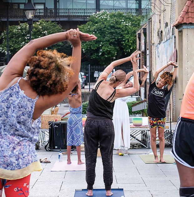 Kiran Bhagat leads a yoga class Saturday at the Juneteenth Freedom Day celebration at the 17th Street Market, featuring drumming, dancing and meditation.