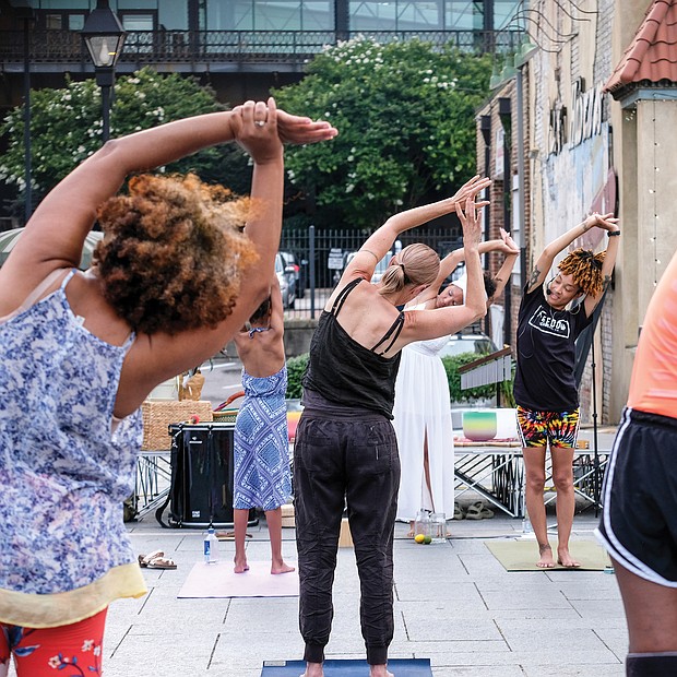 Kiran Bhagat leads a yoga class Saturday at the Juneteenth Freedom Day celebration at the 17th Street Market, featuring drumming, dancing and meditation.