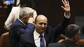 Israel’s new Prime Minister Naftali Bennett raises his hand during a Knesset session June 13 in Jerusalem. Israel’s parliament has voted in favor of a new coalition government, formally ending Prime Minister Benjamin Netanyahu’s historic 12-year rule.